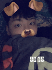 a young man wearing a dog mask with the time of 00:16