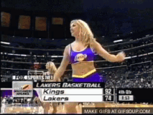 a cheerleader for the lakers basketball team dancing on the court