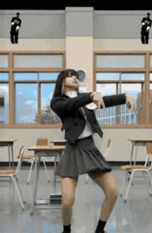 a girl in a school uniform is dancing in a classroom with tables and chairs