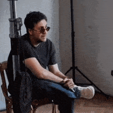a man wearing sunglasses is sitting in a chair