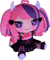 a stuffed doll with pink and purple hair and horns has the letter s on her head