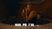 a man standing in a bathtub with the words nuk po t'ni