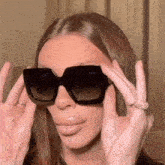 a woman wearing a pair of square sunglasses with the word gucci on them