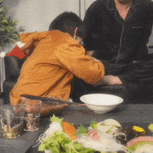 a person sitting on a couch with a bowl of food