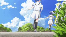 a girl in a white dress with the letter t on it is running with another girl