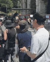 a group of people wearing hats and helmets are standing in a line
