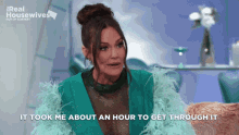 a woman in a green feathered jacket is talking about an hour to get through it