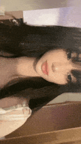 a young woman is taking a selfie in front of a mirror .