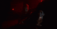 a woman is being attacked by a monster in the dark .