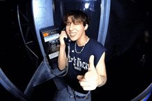 a man giving a thumbs up while wearing a shirt that says " let 's vaca "