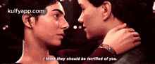 a man and a woman are looking into each other 's eyes and talking .