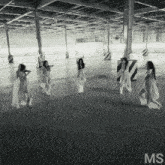 a group of women are dancing in an empty warehouse with the letters ms on the bottom