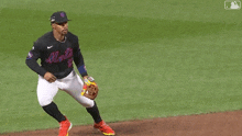 a baseball player wearing a jersey with the number 2 on it is trying to catch a ball