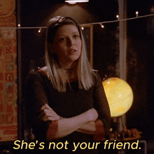 a woman with her arms crossed and the words she 's not your friend