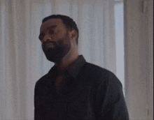 a man with a beard wearing a black shirt