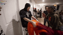 a group of people are gathered in a room and one of them is wearing a shirt that says ' nm '