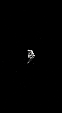 a man is riding a surfboard in the dark .