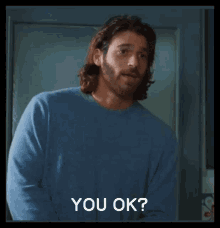 a man with long hair and a beard says " you ok "