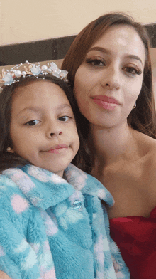 a woman and a little girl pose for a photo