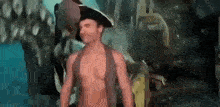 a shirtless man wearing a pirate hat is standing in front of a crowd .