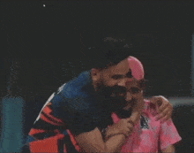 a man wearing a pink shirt that says spl on it