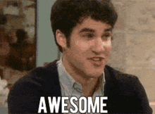 a man in a sweater says awesome in white letters