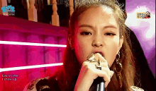 a woman singing into a microphone with the words " every time i show up " on the bottom