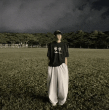 a man standing in a field wearing a shirt that says ' snoopy '