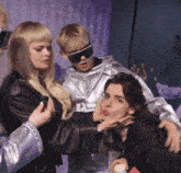 a group of people are posing for a picture and one of them has her hand on another woman 's neck