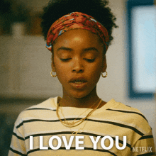 a woman wearing a headband and earrings says i love you
