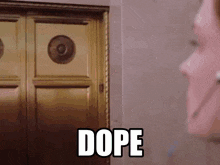 a woman standing in front of a door with the word dope written on it