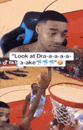 a man sitting in a chair with the words look at dra-a-a-a-a tiktok a-ake