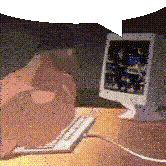 a computer monitor sits on a desk next to a keyboard and mouse