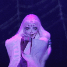 a woman with white hair and purple eyes is standing in front of a spider web ..