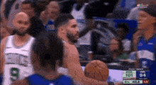 a group of basketball players are playing a game of basketball on a television screen .