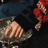 a woman with a ring on her finger holds a bucket of ice