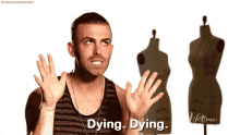 a man is standing in front of mannequins and says dying dying