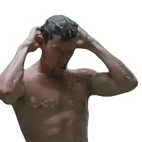 a shirtless man is taking a shower and touching his hair