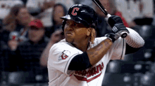 a baseball player with the letter c on his hat