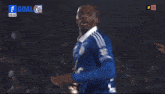 a soccer player is being touched by another player during a game with the score 1 goal
