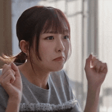 a girl with a ponytail and a t-shirt that says ' i love you ' on the front