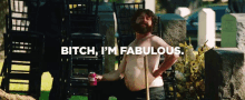 a shirtless man with a beard is holding a can of beer and says bitch i 'm fabulous