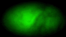 a silhouette of a robot in a green circle with a light coming out of it .