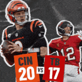 a bengals player is holding a football while a tb player looks on