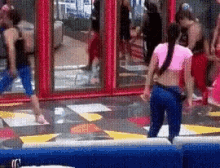 a woman in a pink crop top is standing on a trampoline