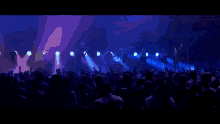 a man is playing drums in front of a crowd