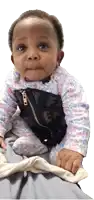 a baby wearing a floral outfit has a black zipper on her chest