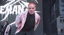 a man with blood on his face is standing in front of a sign that says evans