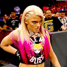 a woman with blonde hair and a bliss shirt on
