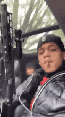 a man smoking a cigarette in a car with a gun